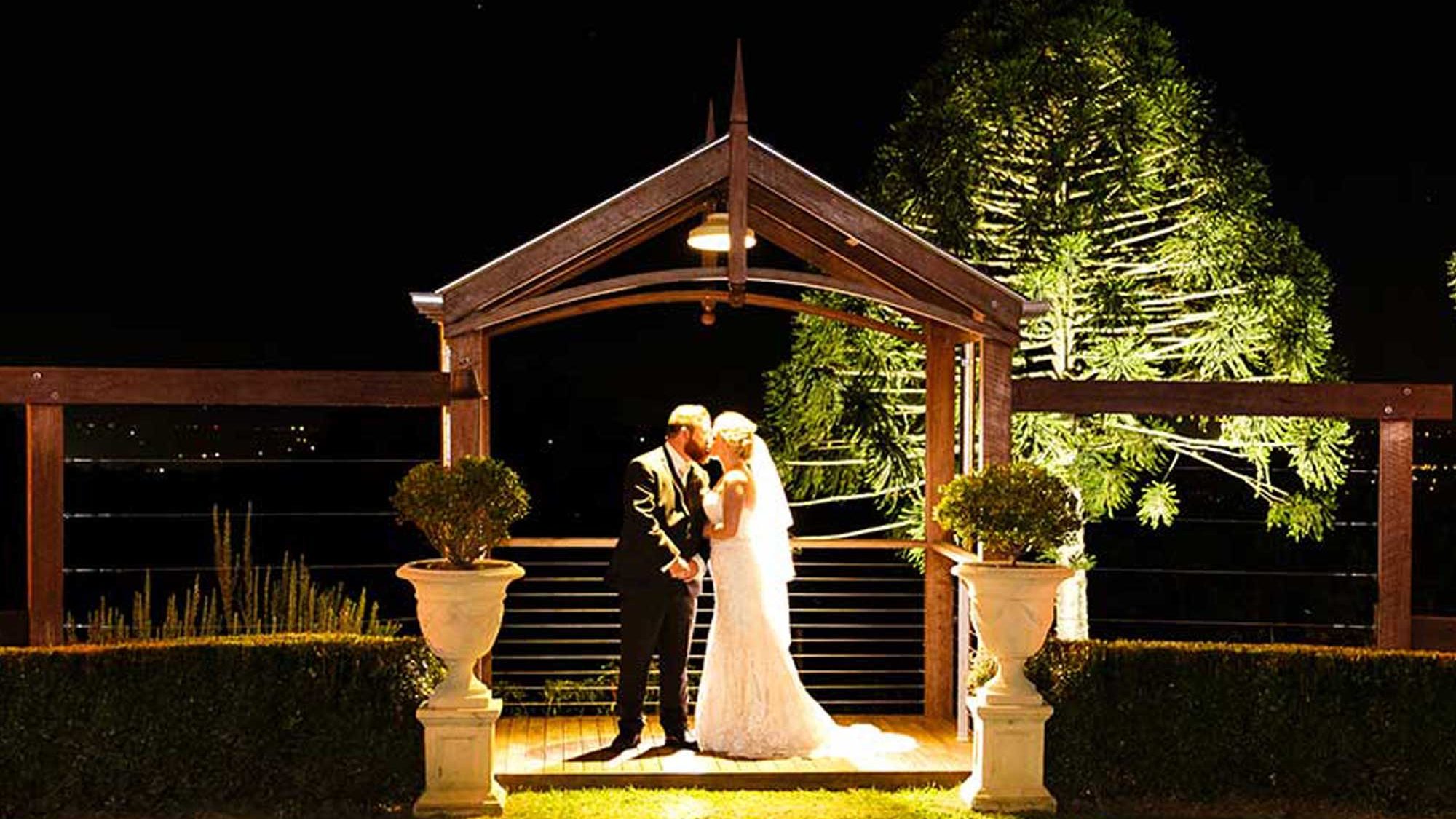 Bride and Groom under arbour at Flaxton Gardens - nighttime